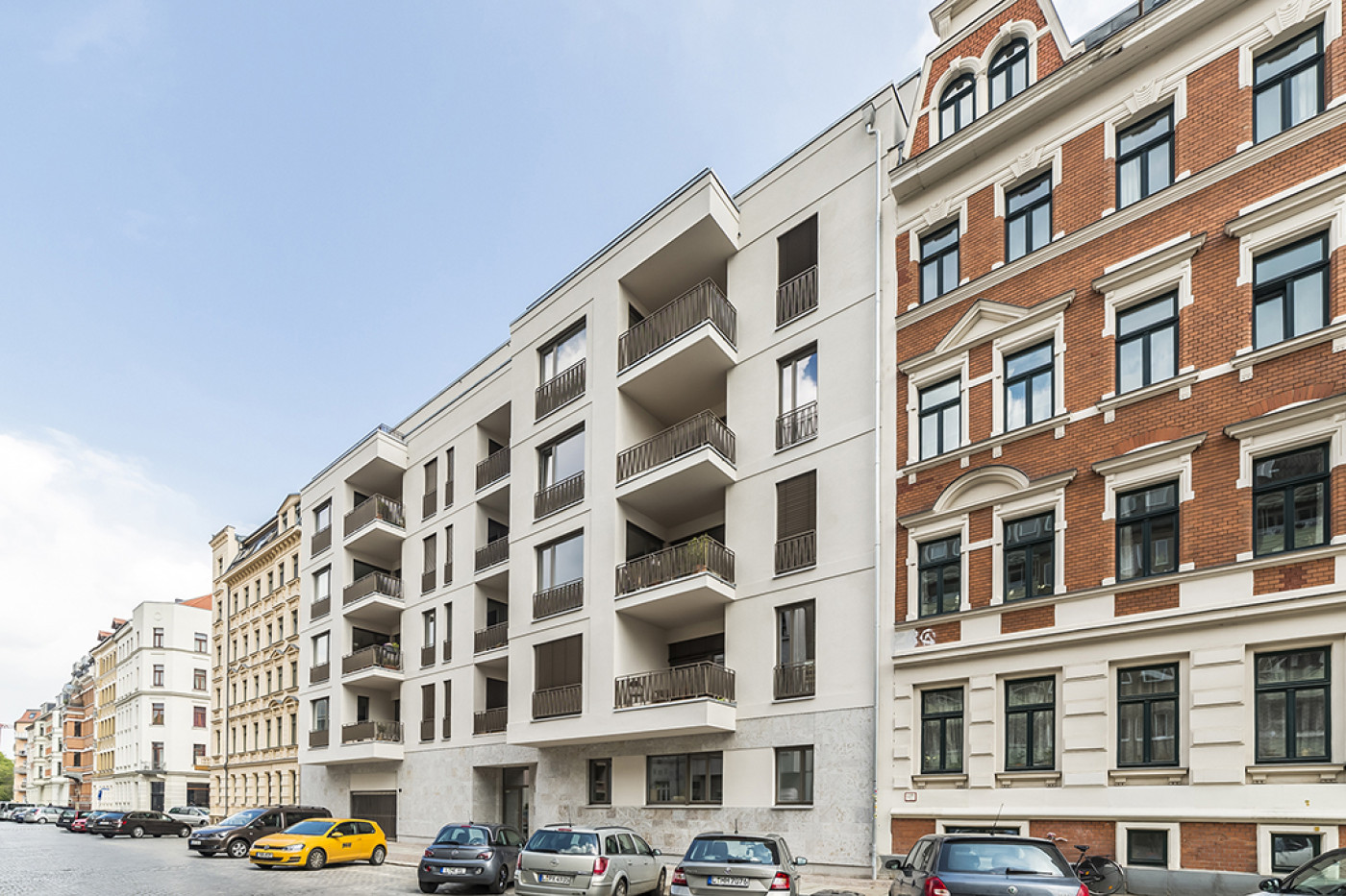 The new building seen from across the street, the terrace to the left and a red brick fa&ccedil;ade to the right.